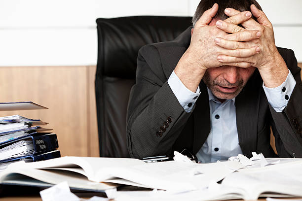 http://www.lollydaskal.com/wp-content/uploads/2018/01/frustrated-businessman-at-desk-with-head-in-hands-picture-id152991279.jpeg